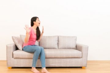 Woman sitting on couch with mind blowing questions.