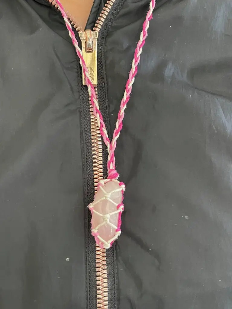 Close up of rose quartz crystal necklace.