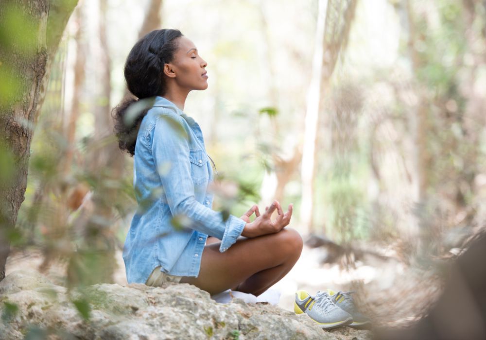Woman meditating & learning how to connect with your higher self.