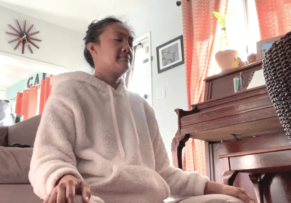 Woman meditating to increase self-awareness.
